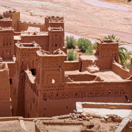 Explore this ancient clay fortress nestled in a stunning desert landscape, offering a glimpse into historical architecture.